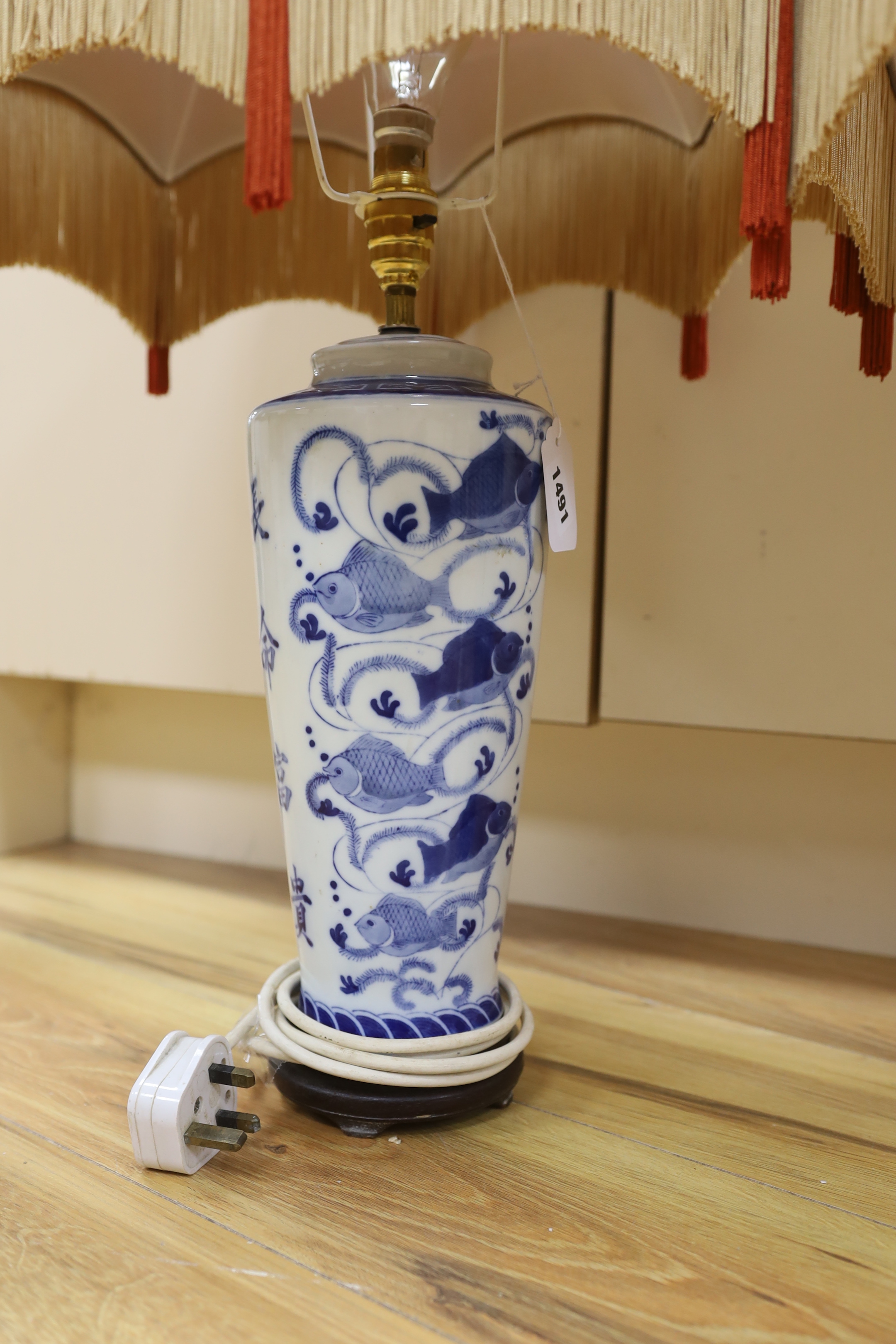 A pair of ‘Chinese’ blue and white table lamps with silk Pagoda shades, 69cm high overall